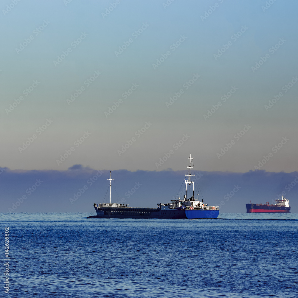 Blue cargo ship leaving Riga and entering Baltic sea