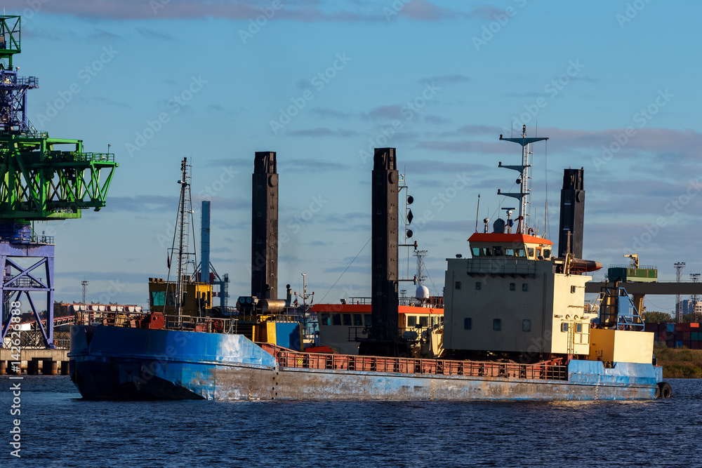 Blue cargo ship in the port of Riga, Europe