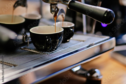 Close up of professional coffee machine making cappuccino and espresso in a cafe.