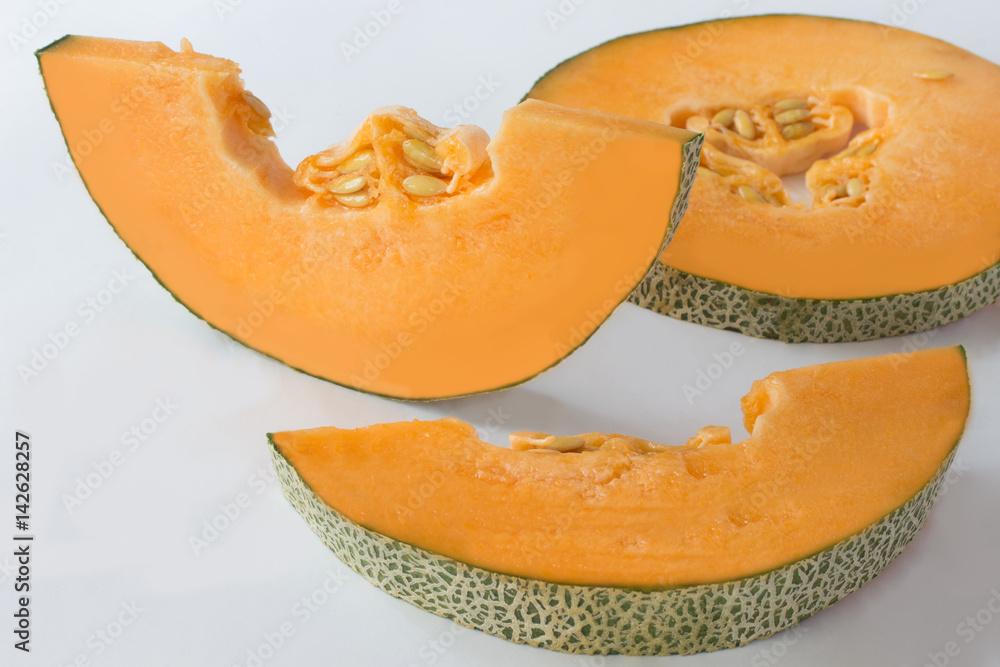 Pumpkin is cut into slices. Closeup. White background Pumpkin is cut into slices. Closeup. White background
