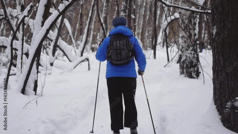 Woman with backpack Cross-Country Skiing Alone in Nature during snowfall in winter in slow motion. 1920x1080 Woman with backpack Cross-Country Skiing Alone in Nature during snowfall in winter in slow motion. 1920x1080