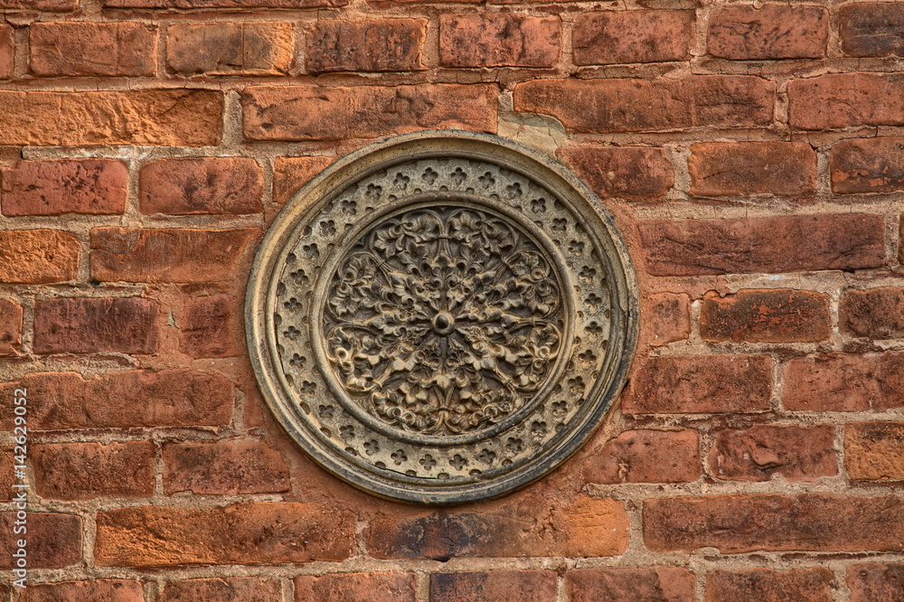 Brick wall with stone rosette