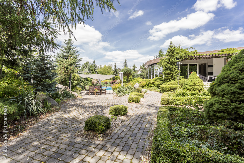 Elegant garden with the paved path