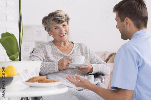 Senior drinking tea in nursing home photo