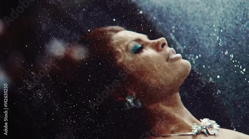 fashionable beautiful woman swims under the water, face in profile