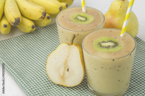 Banana smoothie with kiwi and pear. Picture with space for text or logo