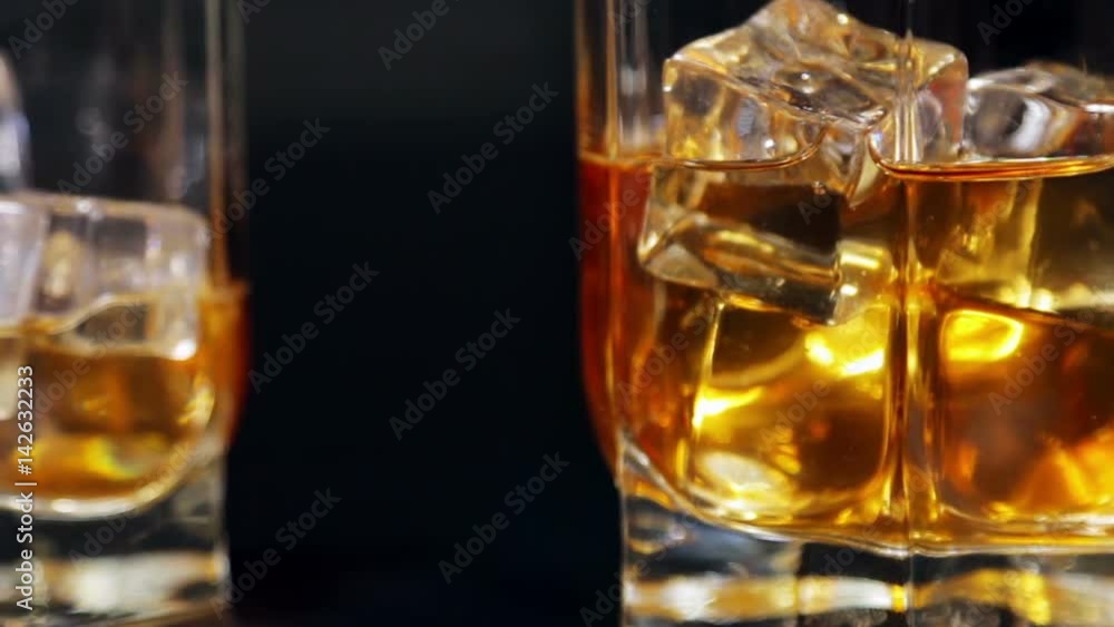 glasses of malt whiskey on a black table. video dolly glasses of malt whiskey on a black table. video dolly
