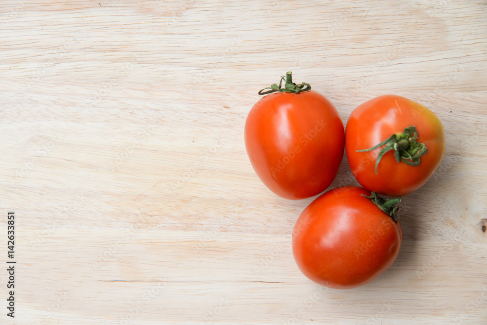 Tomatoes on wooden table background Tomatoes on wooden table background