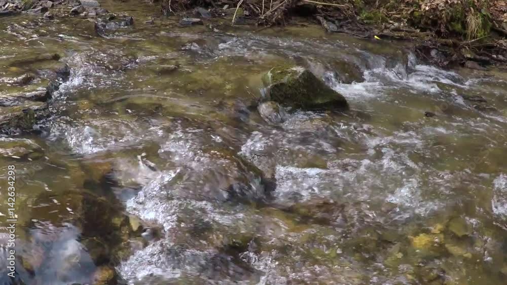 Slow motion rocky forest river flowing movement closeup. Slider dolly used. Slow motion rocky forest river flowing movement closeup. Slider dolly used.