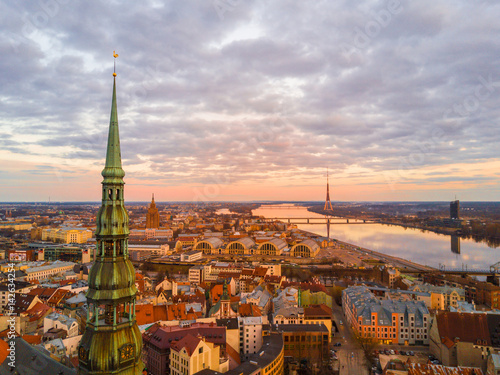 Beautiful aerial view of the St. Peters cathedral in Riga with a highest tower in Europe - TV tower by the Daugava river.