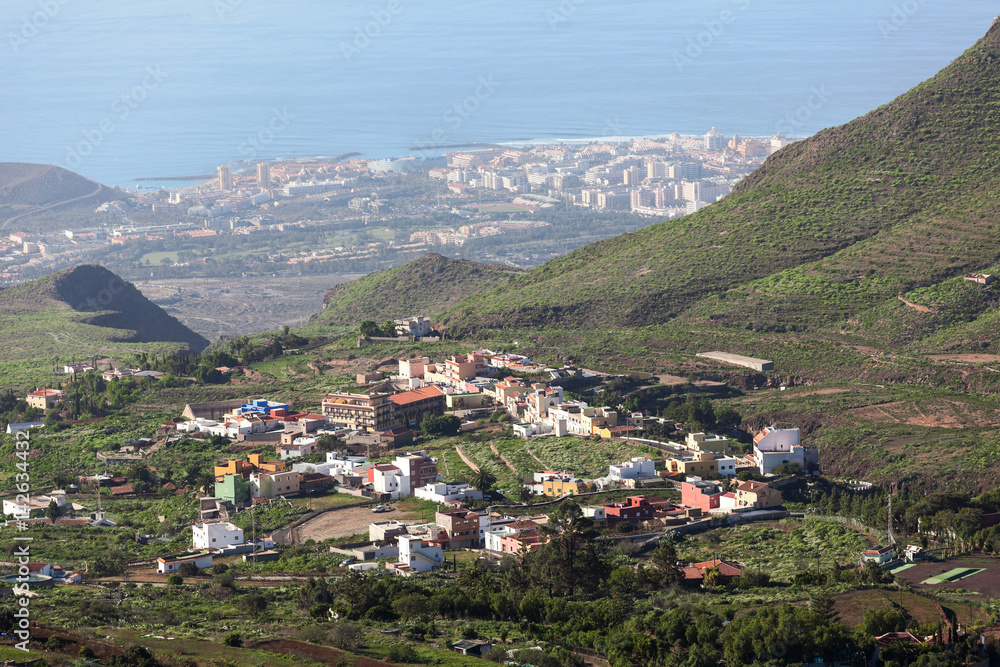 Southern side of Tenerife island with small villages at the mountains slopes and the Atlantic coast, aerial view from mirador. Canary islands, Spain, Europe
