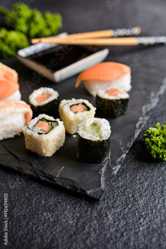 Traditional Asian Maki and Nigiri sushi rolls with salmon and shrimps, served with soya sauce