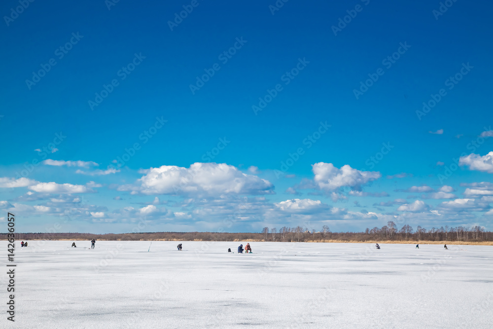 fishermans catching fish on river in winter fishermans catching fish on river in winter