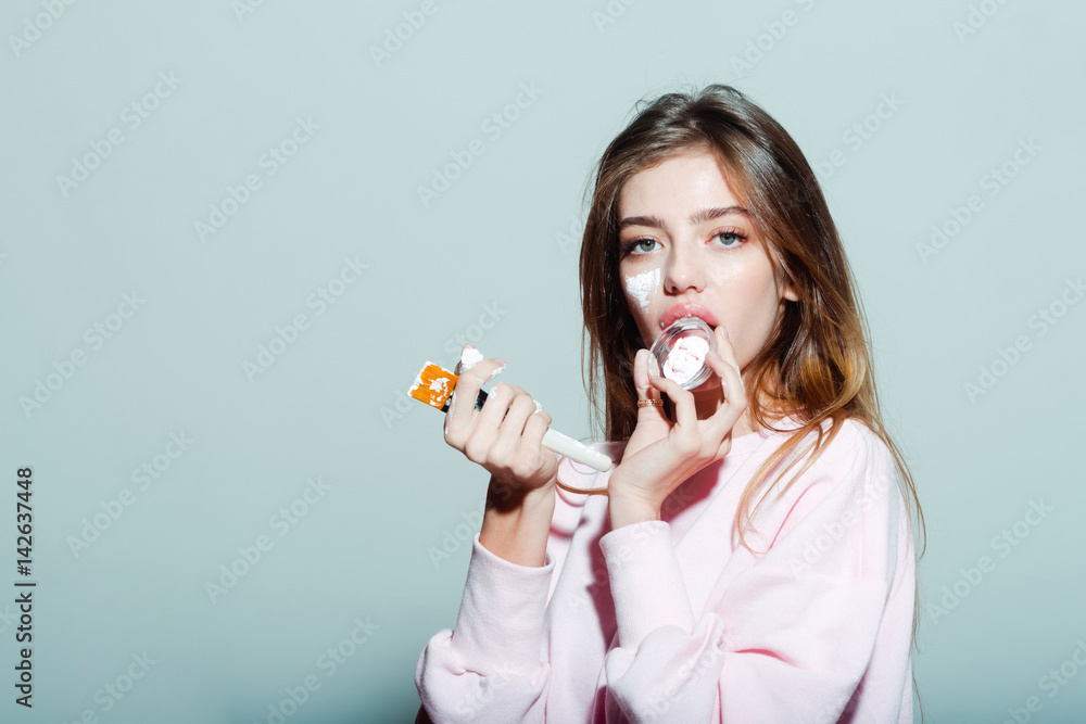 pretty girl putting facial cream or mask on face pretty girl putting facial cream or mask on face