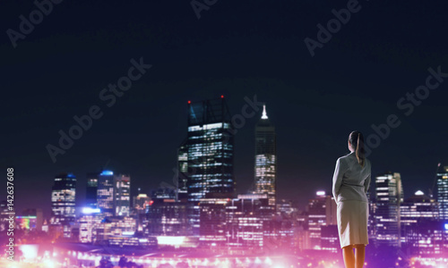Woman looking at night city