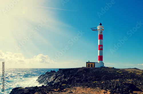 Old lighthouse in Punta de Abona beach. Landmark on the south of Tenerife, Canary islands, Spain.