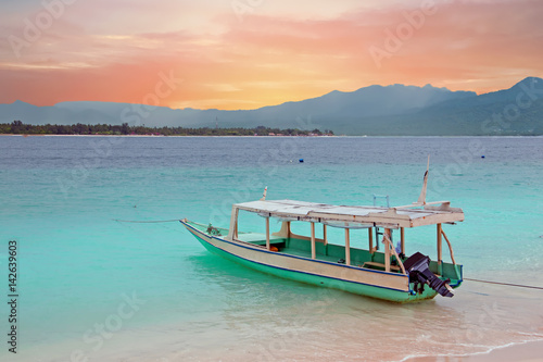 Traditional boat on Gili Meno island beach, Indonesia at sunset