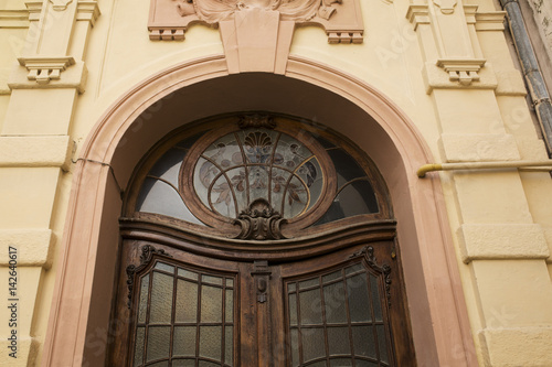 Fragment of arched entrance with stained glass window