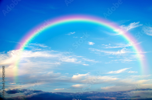 a blue sky rainbow background (clouds) . © slonme