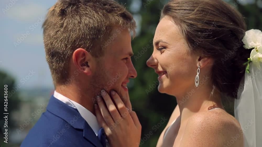 Bride and groom embrace and luxuriate. Happy young couple showing love and sincere emotions Bride and groom embrace and luxuriate. Happy young couple showing love and sincere emotions
