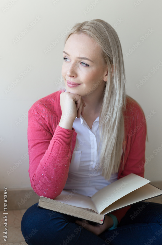 Beautiful blonde woman studying in the hall of the University Beautiful blonde woman studying in the hall of the University