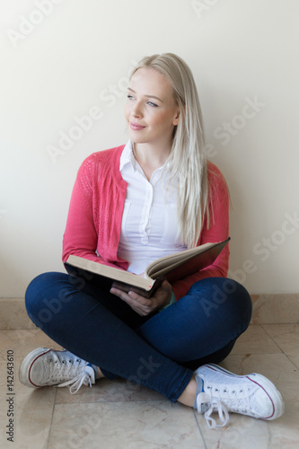 Beautiful blonde woman studying in the hall of the University © Myvisuals