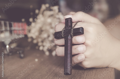 wooden cross in the hand with focus on the cross