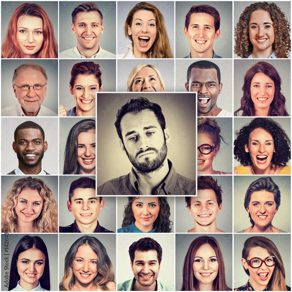 Sad man among group of happy people Sad man among group of happy people