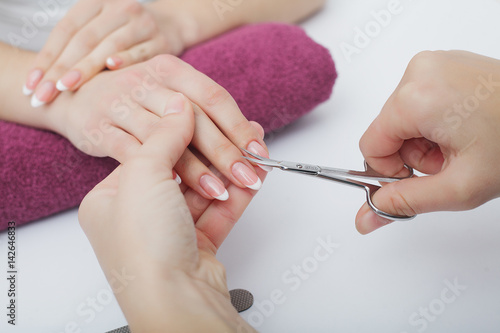 Woman hands in a nail salon receiving a manicure procedure. SPA manicure.