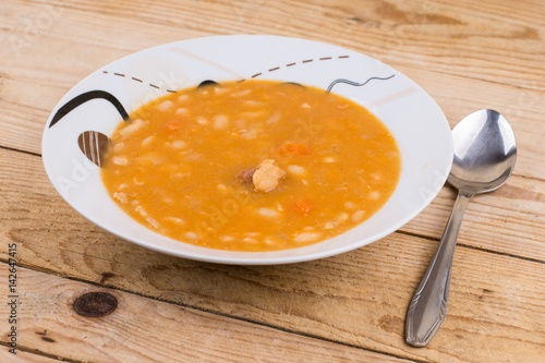 Cooked beans served in the plate on the table