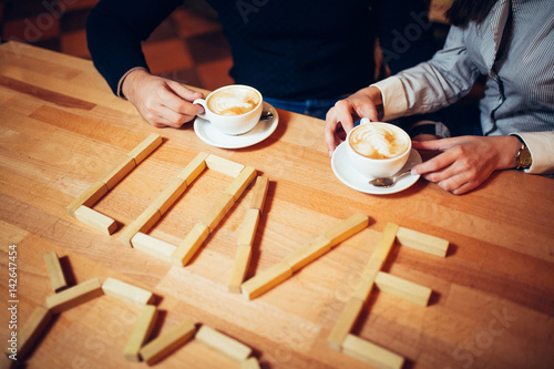 couple hands of coffee on a wooden table