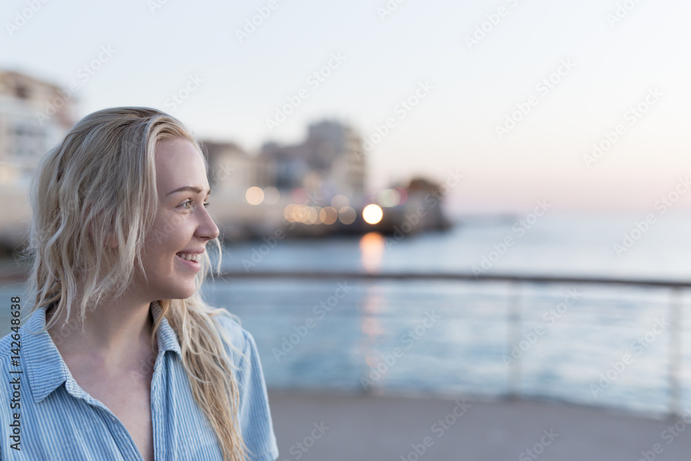 Woman enjoying her free time at the beach in the sunset time. Vacation time. Concept of holiday.
