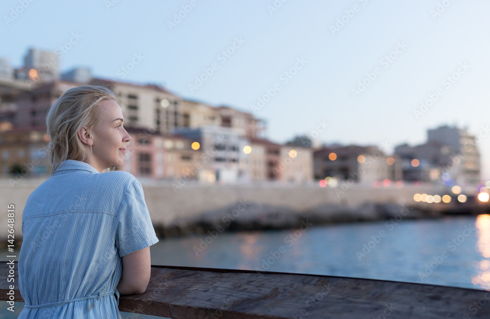 Woman enjoying her free time at the beach in the sunset time. Vacation time. Concept of holiday.