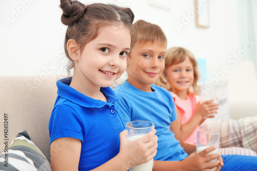 Children sitting on sofa wi...