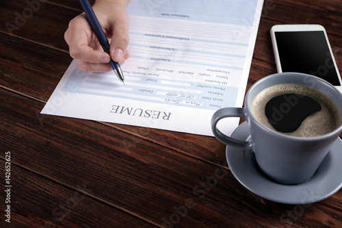 Woman filling resume form o...