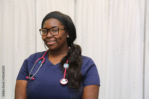 Portrait of a happy African American female healthcare professional, portrait of a nurse with stethoscope