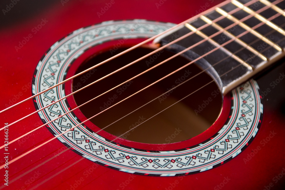 Part of red acoustic guitar. Close up Part of red acoustic guitar. Close up