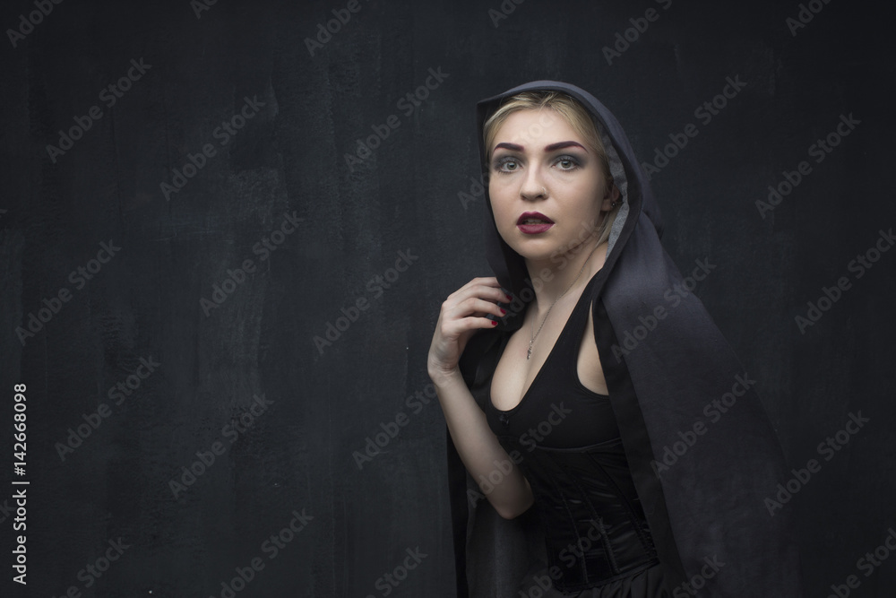 Girl in black on a black background