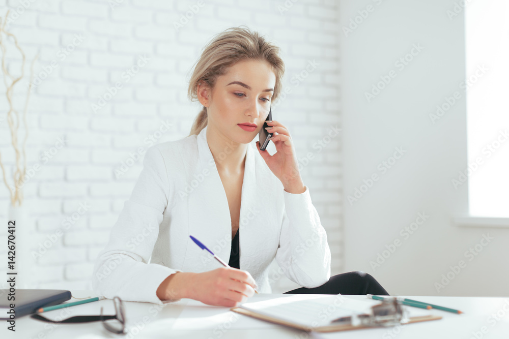 Portrait of beautiful young woman working in the office. Portrait of beautiful young woman working in the office.