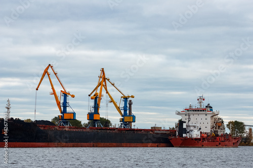 Wallpaper Mural Black cargo ship loading in the port of Riga, Europe Torontodigital.ca
