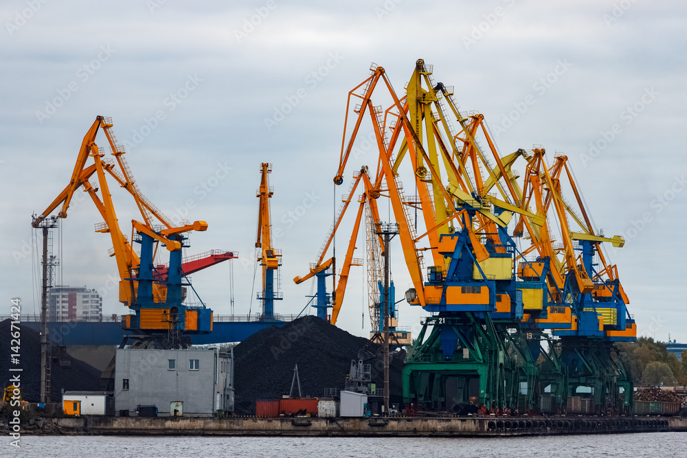 Yellow cargo cranes in the port of Riga, Europe