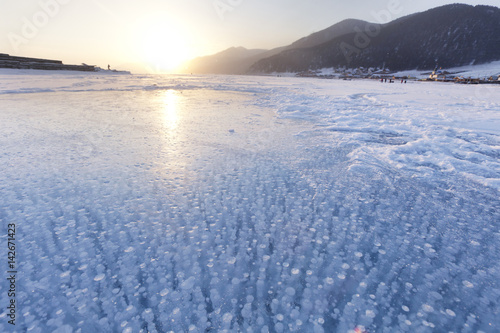 Bubbles in ice of Baikal lake. Winter landscape