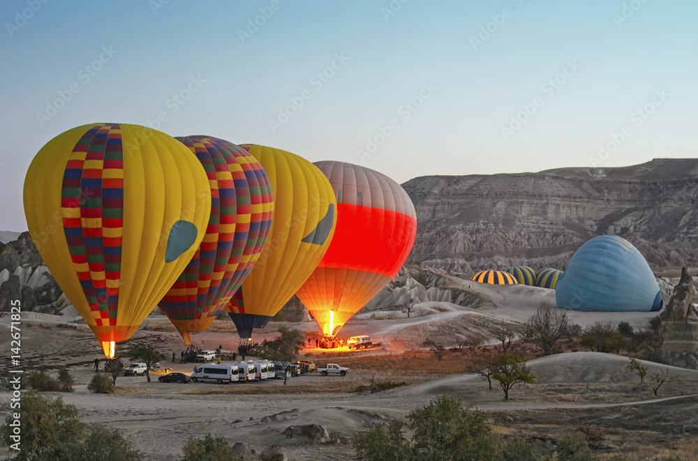 Obraz premium Colorful hot air balloons flying over the valley at Cappadocia, Turkey. Volcanic mountains in Goreme national park