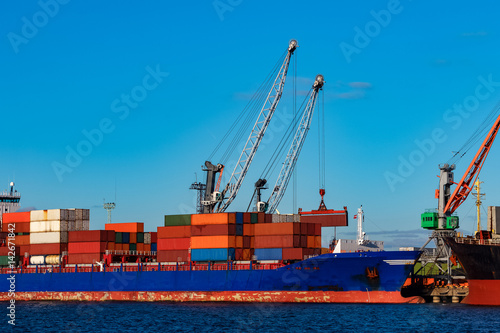 Blue container ship loading in cargo port of Europe