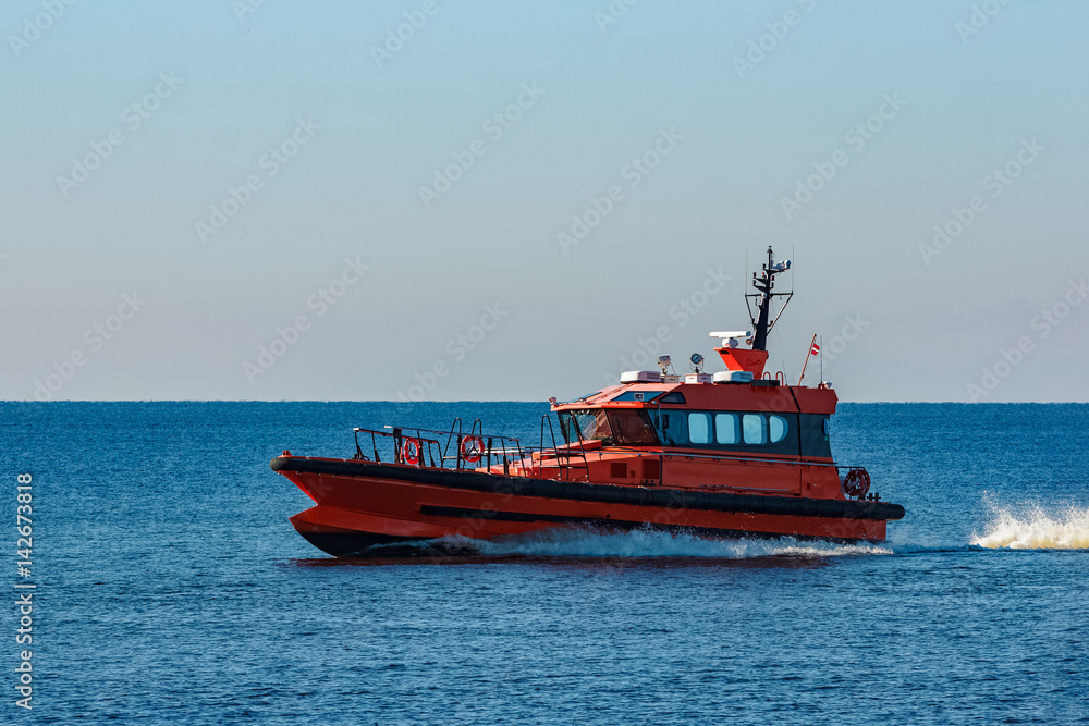 Orange pilot ship moving fast from Baltic sea Orange pilot ship moving fast from Baltic sea