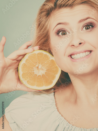 Woman holding fruit green grapefruit