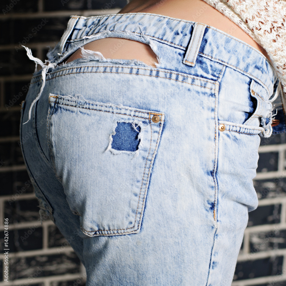 Sexy woman butt in ripped jeans Stock Photo | Adobe Stock