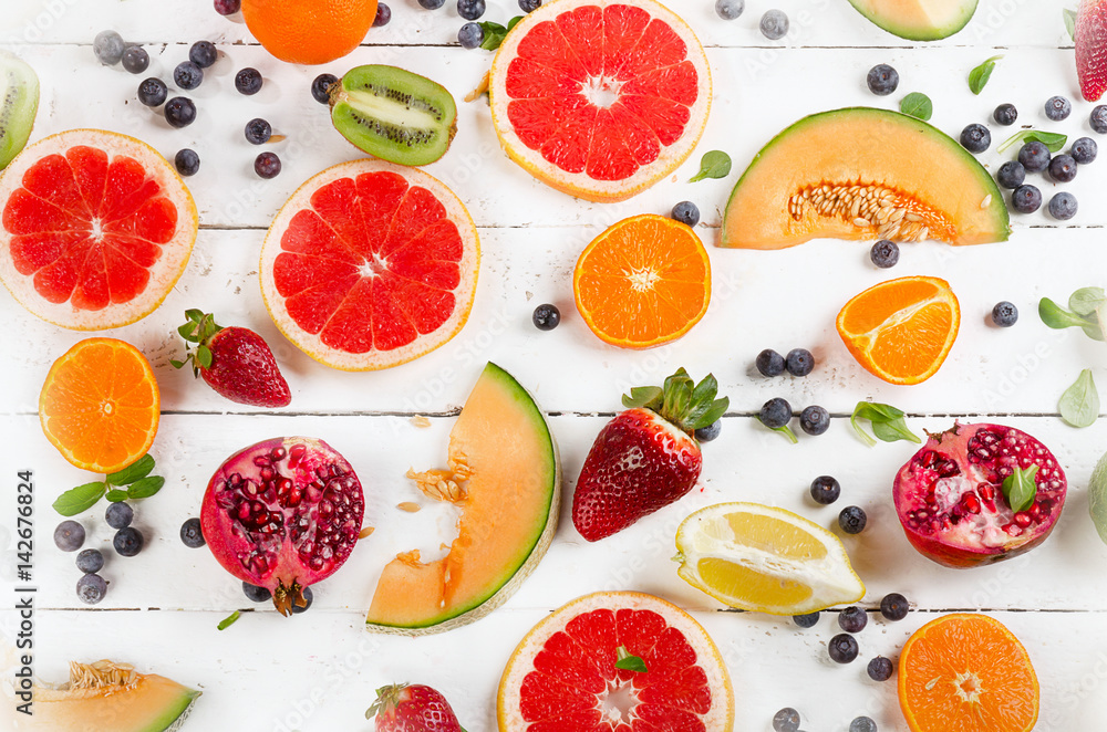 Fresh mixed fruits on a white wooden table. Fresh mixed fruits on a white wooden table.