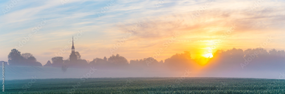 Foggy morning in the field near the village, panorama Foggy morning in the field near the village, panorama