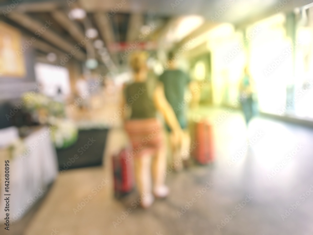 Blurred image of People at queue in front of Automatic ticket machine at train station.